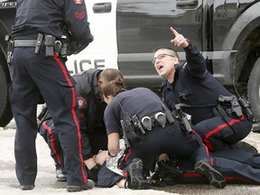 Police attend to Const. Jordan Forget after he was shot in Abbeydale on Tuesday March 27, 2018.