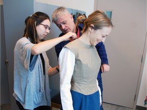 Julie Orton, who will play Cordelia in the upcoming The Shakespeare Company production of King Lear, is fitted for her dress by Olds College costume cutter Danielle Girard and instructor Robert Laflamme.