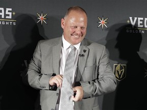 Gerard Gallant adjusts his tie during a news conference Thursday, April 13, 2017, in Las Vegas. The Vegas Golden Knights have hired Gallant as the first coach of the NHL expansion team. (AP Photo/John Locher) ORG XMIT: NVJL108