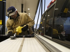 Lloydminster resident Ron Noble fills up his truck and his auxiliary tank at a Co-op Cardlock station on the Alberta side of the border in Lloydminster, Alberta on Thursday, December 22, 2016. The carbon tax applies only on the Alberta side of the border, which divides the prairie city. Ian Kucerak / Postmedia (For Emma Graney story) For Emma Graney's feature about the carbon tax, running Jan. 3