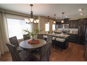 The dining area and kitchen in the Jasper show home at Essential Savanna.
