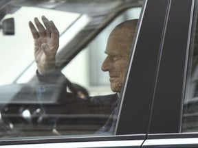 Britain's Prince Philip waves as he leaves the King Edward VII Hospital, after recovering from a planned surgery last Wednesday, in London, Friday, April 13, 2018.