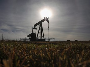 A pumpjack works at a well head on an oil and gas installation near Cremona, Alta.