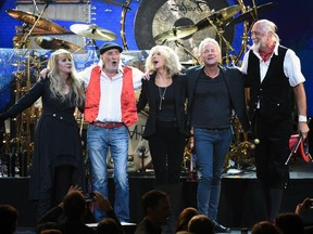 Fleetwood Mac band members from left, Stevie Nicks, John McVie, Christine McVie, Lindsey Buckingham and Mick Fleetwood appear at the 2018 MusiCares Person of the Year tribute honoring Fleetwood Mac in New York. The band said in a statement Monday that Buckingham is out of the band for its upcoming tour. Buckingham left the group once before, from 1987 to 1996.  He'll be jointly replaced by Neil Finn of Crowded House and Mike Campbell of Tom Petty and the Heartbreakers.