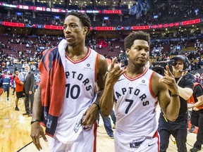 The Raptors' DeMar DeRozan, left, and Kyle Lowry leave the court following a win against the Washington Wizards in Game 2 on Tuesday April 17, 2018.