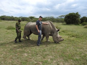 Axel Moehrenschlager, director of conservation efforts at the Calgary Zoo, with Sudan.