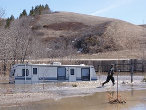 A trailer is swamped by rising water at the High Eagle RV Park in Wheatland County near Rosebud.