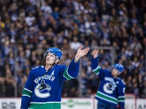 Daniel Sedin, left, and Henrik Sedin take a final skate after the Canucks defeated the Arizona Coyotes 4-3 in overtime. Daniel scored the winning goal on an assist from Henrik.