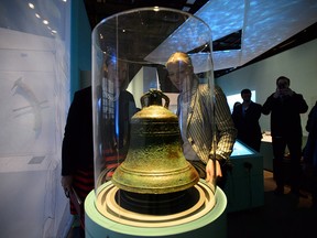 Environment and Climate Change Minister Catherine McKenna, right, and Susan le Jeune d'Allegeershecque, the British High Commissioner to Canada, left, survey the bell from the HMS Erebus at the Canadian Museum of History in Gatineau, Quebec on April 26, 2018. The two shipwrecks of the 1845 Franklin Expedition are now jointly owned by Canada and Inuit through Parks Canada and the Inuit Heritage Trust.