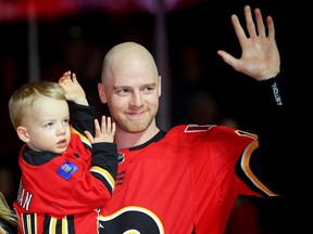 Matt Stajan with son Elliot, during a ceremony honouring the Flames forward for playing in 1000 NHL games.