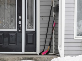 Hockey sticks sit on the front porch of a house in Humboldt, Sask., to pay tribute to the 15 lives lost after a bus carrying the Broncos junior hockey team collided with a semi truck.
