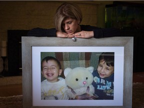 Tima Kurdi sits with a photo of her late nephews Alan, left, and Ghalib Kurdi at her home in Coquitlam, B.C., on Monday August 22, 2016.