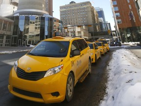Taxis wait in downtown Calgary.