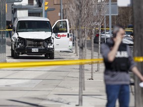 Police inspect a van suspected of being involved in a collision injuring at least eight people at Yonge St. and Finch Ave. on April 23, 2018 in Toronto. A suspect is in custody.