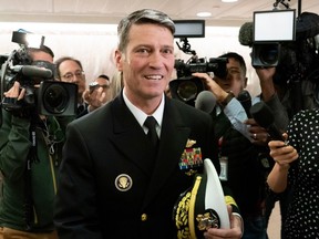 In this April 24, 2018, file photo, Rear Adm. Ronny Jackson, Donald Trump's choice to be secretary of the Department of Veterans Affairs, leaves a Senate office building after meeting individually with some members of the committee that would vet him for the post, on Capitol Hill in Washington.