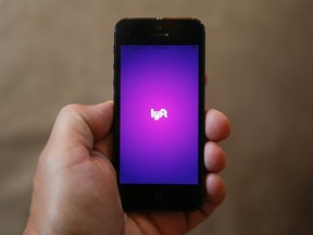 A smartphone displays the Lyft app. Lyft is competing with Uber in its expansion into Canada.