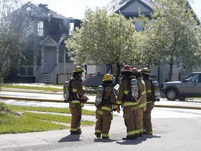 Firefighters at the scene of a house fire in the 400 block of Country hills Drive NW in Calgary, on Saturday May 19, 2018. Leah Hennel/Postmedia