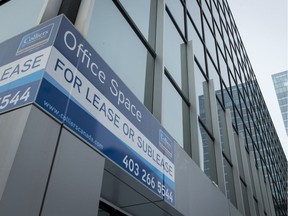 A lease-opportunity sign hangs on a building in downtown Calgary