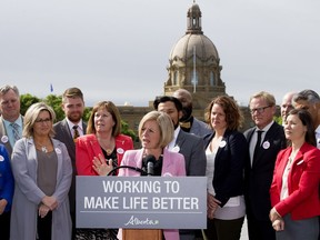 Surrounded by members of her NDP caucus, Alberta Premier Rachel Notley comments on the Government of Canada's purchase of the Trans Mountain Pipeline and associated assets, during a press conference outside the Alberta Legislature in Edmonton on Tuesday, May 29, 2018.