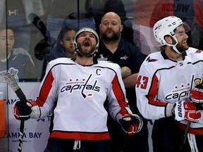 Alex Ovechkin, left, and Tom Wilson of the Capitals celebrate after beating the Tampa Bay Lightning 4-0 in Game 7 of the Eastern Conference final on Wednesday night at Amalie Arena in Tampa, Fla.