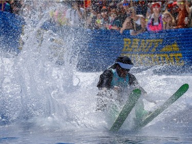 Matt McGlone hits a man-made pond ice water during the 90th annual Slush Cup at Banff's Sunshine Village. The event marks the end of the ski season in Alberta.