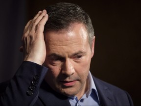 Jason Kenney adjusts his hair Sunday as he speaks to the media at his first convention as leader of the United Conservative Party in Red Deer.