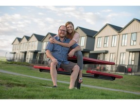 Kyle Girard and Marni Hutchinson infront of the Arrive at the Landing townhome in Okotoks.