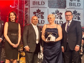 Shannon Lenstra, founder of Kon-strux Renovations, holds the award for Renovator of the Year.