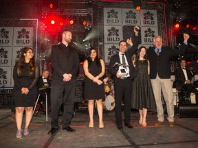 Riverview Custom Homes' president Christopher York, holding award, celebrates with his team after being named Builder of Merit.