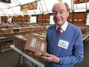 Volunteer Gerry Morgan holds a 110-year-old rare book at the RESET Society of Calgary Annual Book Sale on Wednesday, May 2, 2018. The book Through the Mackenzie Basin was worth about $150 but was a bargain at the sale going for $75 and was just one of the unique finds at the sale which goes from May 2-6.