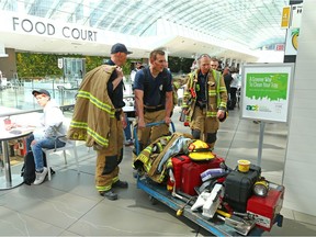 Firefighters leave after helping to recover a body in  Calgary's CORE mall food court after reports it had been found in the wall of the women's washroom on Monday, April 30, 2018.