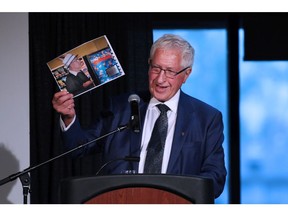 Life-long friend and business partner Bob Brawn holds up a photograph as he speaks about Frank King during a celebration of life at the Red and White Club at McMahon Stadium on Thursday, May 17, 2018. Gavin Young/Postmedia