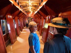 Liam Dubreuil talks with Heritage Park's Barb Munro while having an exclusive tour of the park's Colonist car under restoration at the park on Monday, May 21, 2018. The Dubreuil family were the winners of the Journey of a Lifetime contest which included a private tour of Heritage Park. Gavin Young/Postmedia