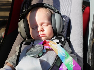 Three-month-old Finley Newman showed off his dad Devin's finisher medal after cruising and snoozing in his stroller through the Jugo Juice 10 KM event at the Scotiabank Calgary Marathon at Stampede Park on Sunday May 27, 2018.