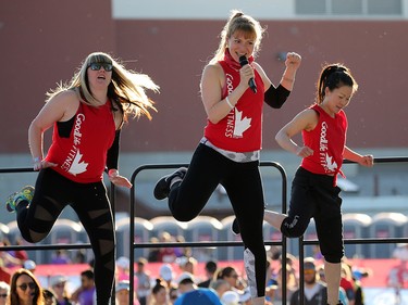 GoodLife fitness instructors warm up runners before the start of the Scotiabank Calgary Marathon and Half Marathon at Stampede Park on Sunday May 27, 2018.