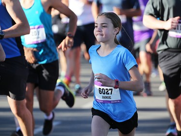 Jamie Galls smiles as she heads off the start of the Jugo Juice 10 KM event during the Scotiabank Calgary Marathon Stampede Park on Sunday May 27, 2018.