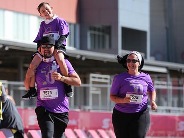 Danijel Slisko carries son Anton on his shoulders as he runs to the finish of the Jugo Juice 10 KM event at the Scotiabank Calgary Marathon at Stampede Park on Sunday May 27, 2018.