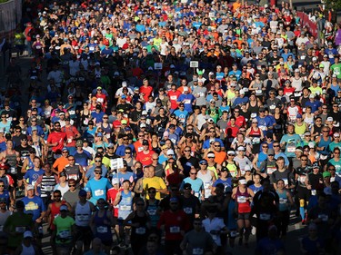 Runners head out from the start of the Scotiabank Calgary Marathon and Half Marathon at Stampede Park on Sunday May 27, 2018.