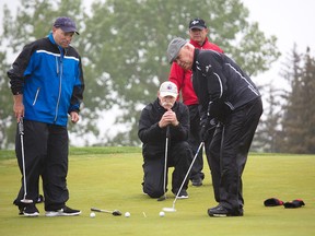 Lanny McDonald poses with teammates as he and 220 other golfers braved the cold and rain to raise money for Cerebral Palsy Kids and Families in the 24th annual Calgary Flames Alumni Masters Tournament at Heritage Pointe on Thursday May 31, 2018. Gavin Young/Postmedia