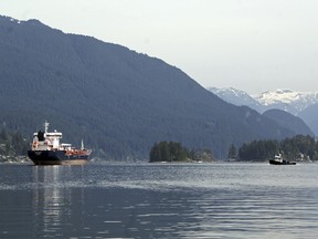 This May 3, 2018 photo shows the Kirkeholmen oil tanker anchored outside the Kinder Morgan Inc. Westridge oil terminal in Vancouver, Canada, at the end of the Trans Mountain pipeline that begins in northern Alberta. A project to expand the pipeline would triple the capacity of the existing pipeline to ship oil across the snow-capped peaks of the Canadian Rockies and to the Pacific Ocean, resulting in a seven-fold increase in the number of tankers in an environmentally sensitive area dependent on tourism and fishing. (AP Photo/Jeremy Hainsworth) ORG XMIT: CPT501