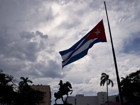 A Cuban flag is seen flying at half-mast near a state of national hero Jose Marti, marking the start of two days of national mourning, in Havana, Cuba, Saturday, May 19, 2018. Montreal-based travel agency says hundreds of Canadians who were stuck in Cuba since a plane crash last week are returning home. Caribe Sol said Monday that Cubana Airlines was resuming operations after the passenger jet crash on Friday killed 111 people. (THE CANADIAN PRESS/AP, Ramon Espinosa)