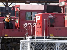 A Canadian Pacific Railway boards a locomotive in a marshalling yard in Calgary, Wednesday, May 16, 2012.