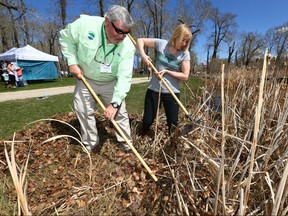 David Bloom, President of Ducks Unlimited (L)  joins Laureen Harper at Boots at the Bow clean up event held at Pearce Estate Park in Calgary Sunday, May 6, 2018. Teams of volunteers joined together to clean up and spruce up the area around the Bow Habitat Station in the park. Some picked up garbage along the pathways and among the trees and wetlands and others dug in and raked leaves, garbage and large branches out of the wetlands. Jim Wells/Postmedia