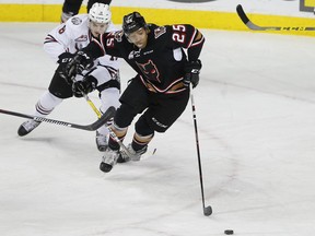Crystal Schick/ Independent CALGARY, AB -- Calgary Hitmen Aaron Hyman fights off Red Deer Rebels Grayson Pawlenchuk during game action in Calgary, on December 9, 2016. -- (Crystal Schick/Independent)