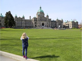 Writer's daughter taking a picture of the Parliament Buildings in Victoria. Courtesy Curt Woodhall