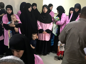 Russian women who were sentenced to life in prison for joining the Islamic State wait at Baghdad’s Central Criminal Court with their children.