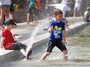 Kids splash around at Olympic Plaza on the opening day of the Calgary International Children’s Festival on Wednesday, May 23, 2018. The festival — the largest of its kind in Canada — runs until May 26.