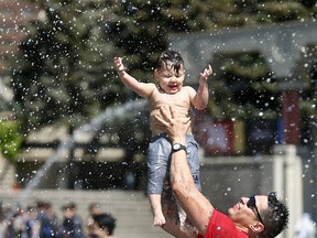 Dad, Dusty Senoffsky with son Dominic,1, cool down as the Calgary International Childrenís Festival kicked off from May 23 to 26. After 32 years, Kidsfest is one of the largest festivals of its kind in Canada, welcoming thousands of kids to various arts and entertainment at the Olympic Plaza with tons of free events running from 9:30am to 10:30pm in Calgary on Wednesday May 23, 2018. Darren Makowichuk/Postmedia