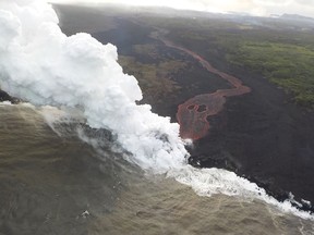 This image released by the US Geological Survey on May 22, 2018 shows by the end of the afternoon, only a single ocean entry that was active as the lava channel originates from fissure 22, during a late afternoon overflight of the lower East Rift Zone of K?lauea Volcano on May 21, 2018.  Authorities in Hawaii have warned of dangerous "laze" fumes as molten lava from the erupting Kilauea volcano reached the Pacific Ocean. Two lava flows "reached the ocean along the southeast Puna coast overnight," on Hawaii's Big Island, the US Geological Survey, which monitors volcanoes and earthquakes worldwide, said in a statement May 20, 2018.   / AFP PHOTO / US Geological Survey / HO / RESTRICTED TO EDITORIAL USE - MANDATORY CREDIT "AFP PHOTO / US Geological Survey/HO" - NO MARKETING NO ADVERTISING CAMPAIGNS - DISTRIBUTED AS A SERVICE TO CLIENTS  HO/AFP/Getty Images