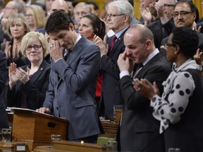 Prime Minister Justin Trudeau wipes his eye while he is applauded while making a formal apology to individuals harmed by federal legislation, policies, and practices that led to the oppression of and discrimination against LGBTQ2 people in Canada, in the House of Commons in Ottawa, Tuesday, Nov.28, 2017.